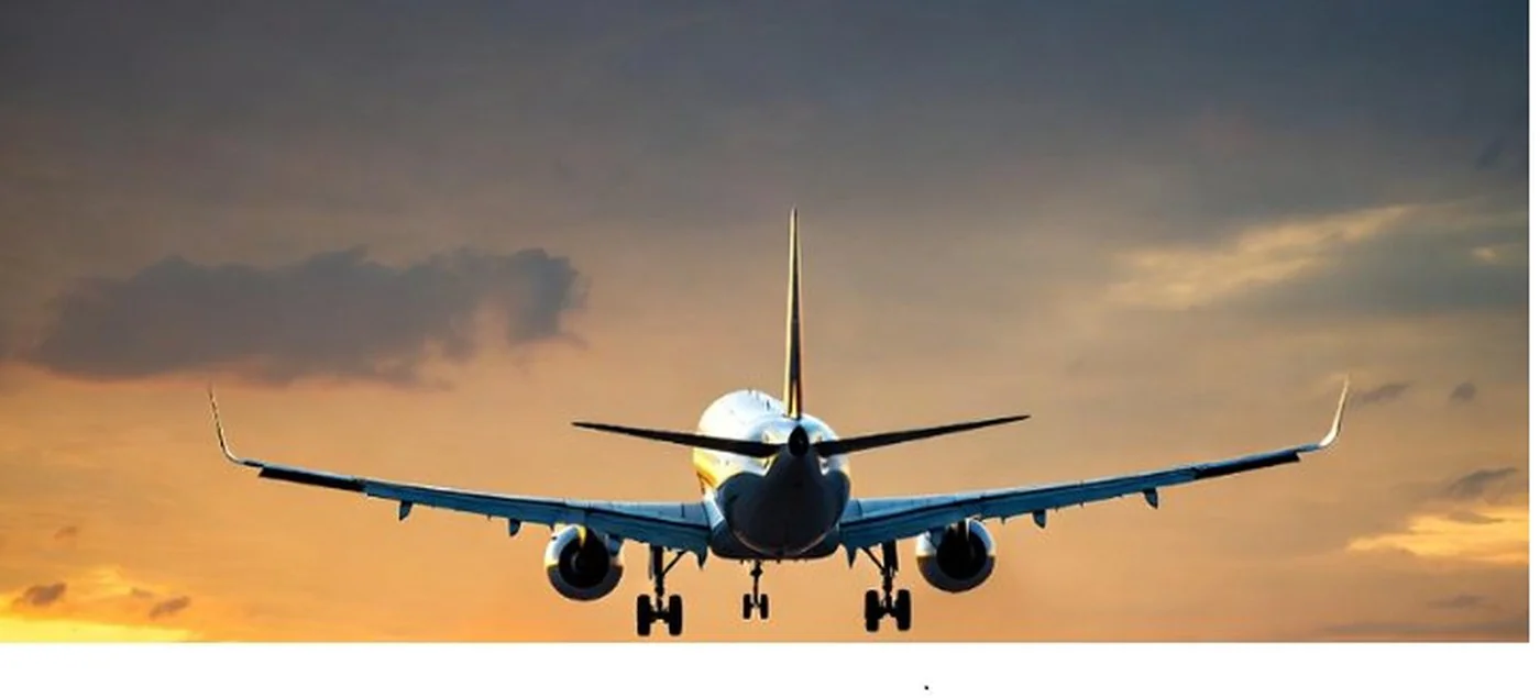 Plane departing at sunset